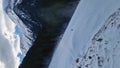 Aerial view to the snowy slope with a freeride snowboarder having fun