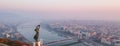 Aerial view to the Statue of Liberty with Elisabeth Bridge and River Danube taken from Gellert Hill on sunrise in fog in Royalty Free Stock Photo