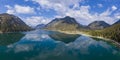 Aerial view to wonderful lake plansee in alps landscape with reflections of sky