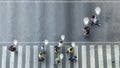 Aerial view and top view with blur man with smartphone walking converse with busy city crowd move to pedestrian crosswalk. concept Royalty Free Stock Photo