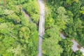 Aerial view top down directly above lush rain forest trees at Malaysia. Jungle road with bridge over a small river. Untouched Royalty Free Stock Photo