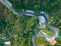 Aerial view top down drone shot above the winding mountain road between the trees rainforest,Phuket Thailand,in summer season Royalty Free Stock Photo