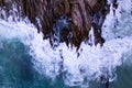 Aerial view Top down seashore big wave crashing on rock cliff Beautiful dark sea surface in sunny day summer background Amazing Royalty Free Stock Photo