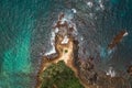 Aerial view Top down seashore big wave crashing on rock cliff Beautiful dark sea surface in sunny day summer background Royalty Free Stock Photo