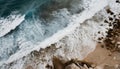 Aerial view top seashore, rocky coast, waves crashing on rock cliff. Blue ocean surface sunny summer Royalty Free Stock Photo