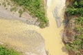 Aerial view or top view of two tropical rivers merging together in one large brown colored river in the tropics