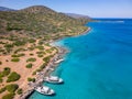 Aerial view of tourist boats and swimmers in crystal clear waters off a small beach (Kolokitha, Crete, Greece Royalty Free Stock Photo