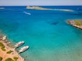 Aerial view of tourist boats and swimmers in crystal clear waters off a small beach (Kolokitha, Crete, Greece Royalty Free Stock Photo