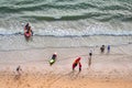 Aerial view of tourist people crowds is relaxing with their activity on the beautiful beach with warm sunlight at summertime in