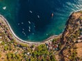 Aerial view of tourist town with blue sea water and boats, drone shot. Amed, Bali Royalty Free Stock Photo