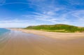 Aerial view of tourists on a huge, wide sandy beach on the coast of Wales Rhossili, Wales