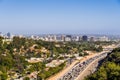 Aerial view towards the skyline of Westwood neighborhood; highway 405 with heavy traffic in the foreground; Los Angeles, Royalty Free Stock Photo
