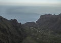 Aerial view towards the valley of village Taguluche with small houses, sharp cliffs and atlantic ocean, viewpoint