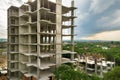 Aerial view of tower lifting crane and concrete frame of tall apartment residential building under construction in a city. Urban Royalty Free Stock Photo