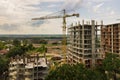 Aerial view of tower lifting crane and concrete frame of tall apartment residential building under construction in a city. Urban Royalty Free Stock Photo