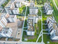 Aerial view of tower lifting crane and concrete frame of tall apartment residential building under construction in a city. Urban Royalty Free Stock Photo