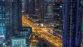 Aerial view of towers in Business Bay with traffic on the road night timelapse. Royalty Free Stock Photo