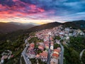 Aerial view of a town in the mountains under the shaded cloudy sunset sky Royalty Free Stock Photo