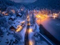 Aerial view of town in snow, road, forest, lake and houses Royalty Free Stock Photo