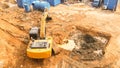 Aerial view of Tracked excavator starts digging ground preparing to build condominium. track hoe working. Royalty Free Stock Photo