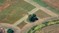 Aerial View of a tractor cutting the green grass field in a farm. Royalty Free Stock Photo