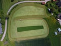 Aerial view of a Tractor fertilizing a cultivated agricultural field. Royalty Free Stock Photo