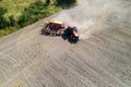 Aerial view of the tractor in the field, agricultural field work, sowing work in the field at sunset Royalty Free Stock Photo