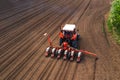 Aerial view of tractor with mounted seeder performing direct seeding Royalty Free Stock Photo