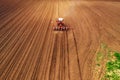 Aerial view of tractor with mounted seeder performing direct seeding Royalty Free Stock Photo