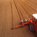 Aerial view of tractor with mounted seeder performing direct seeding Royalty Free Stock Photo