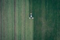 Aerial view of a tractor mowing a green fresh grass field, a farmer in a modern tractor mowing a green fresh grass field Royalty Free Stock Photo