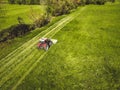 Aerial view of tractor mowing a grass field in the country side Royalty Free Stock Photo