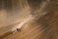 Aerial View. Tractor Plowing Field. Beginning Of Agricultural Spring Season. Cultivator Pulled By A Tractor In