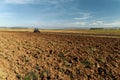 Aerial view of the tractor plows in the field