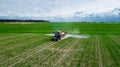 Aerial view, Tractor spraying pesticides at soy bean fields Royalty Free Stock Photo