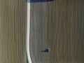 Aerial view of a tractor working in an agricultural field at sunset near Aquileia, Udine, Friuli Venezia Giulia, Italy Royalty Free Stock Photo