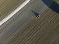 Aerial view of a tractor working in an agricultural field at sunset near Aquileia, Udine, Friuli Venezia Giulia, Italy Royalty Free Stock Photo