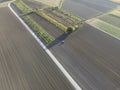 Aerial view of a tractor working in an agricultural field at sunset near Aquileia, Udine, Friuli Venezia Giulia, Italy Royalty Free Stock Photo