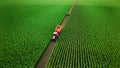 Aerial view of tractor working in corn fields. 3d render