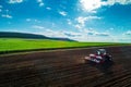 Aerial view of tractors working on the harvest field Royalty Free Stock Photo