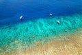 Aerial view of traditional outrigger type boats with snorkelers and swimmers over a tropical coral reef in a clear, warm ocean Royalty Free Stock Photo