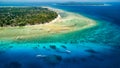 Aerial view of traditional outrigger type boats with snorkelers and swimmers over a tropical coral reef in a clear, warm ocean Royalty Free Stock Photo