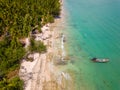 Aerial view of traditional Thai longtail fishin boats moored off a small, palm tree lined tropical beach (Khao Lak, Thailand Royalty Free Stock Photo