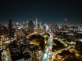 Aerial view of traffic on multilane expressway in night metropolis. Illuminated streets and high rise downtown buildings Royalty Free Stock Photo