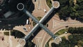 Aerial view of traffic. Time lapse of busy traffic on roundabout with nice architecture pedestrian cross above