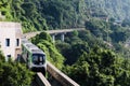 Aerial view of train of Chongqing metro arriving to the Shapingba Station and crossing the mountains