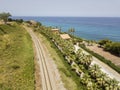 Aerial view of train tracks crossing the coast with sea Royalty Free Stock Photo