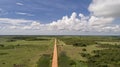 Aerial view of Transpantaneira dirt road crossing straight the North Pantanal Wetlands, blue horizon with white clouds, Mato Royalty Free Stock Photo