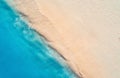 Aerial view of clear blue sea with waves and empty sandy beach Royalty Free Stock Photo