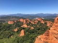 Aerial view of trees and red rock formations under a blue sky on a sunny day Royalty Free Stock Photo